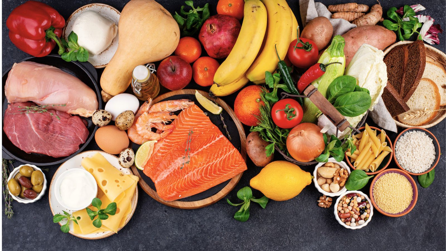 Mediterranean table spread with olive oil, vegetables, legumes and bread shared between plates.